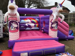 Unicorn Castle with Slide, a bounce and slide combo for hire from Happy Days Bouncy Castles