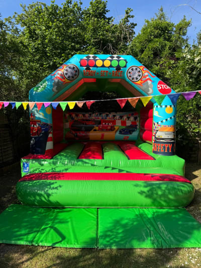 Cars Castle (12ft x 12ft), a bouncy castle for hire from Elmbridge Inflatables