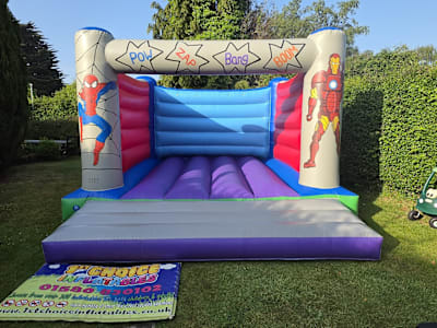 Adult Bouncy Castle Super Heroes themed 15ft x 15ft, a adult bouncy castle for hire from 1st Choice Inflatables