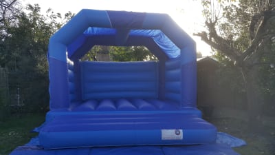 BLUE BOUNCY CASTLE 15FT vs 15ft, a bouncy castle for hire from All Bounce Surrey
