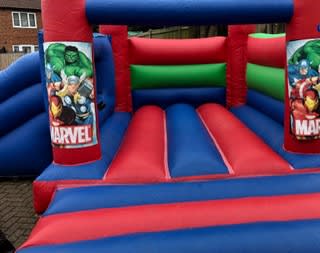 Marvel Castle with Slide, a bounce and slide combo for hire from Happy Days Bouncy Castles