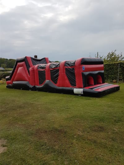 2 Part Red & Black Energy Obstacle Course, a assault course for hire from Alpha Bouncy Castles & Events
