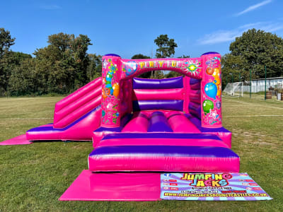 Low Height Party Fun Castle with Side Slide, a bounce and slide combo for hire from Jumping Jacks Bouncy Castles