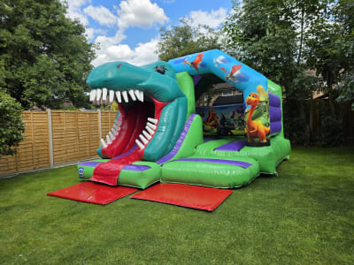 15ft x 12ft Dino 3D Bouncy Castle With Slide, a bounce and slide combo for hire from MLM Bouncy Castles