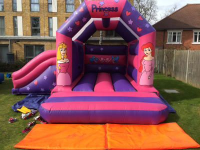 17ft x 15ft Princess slide bouncy castle, a bounce and slide combo for hire from TFG Bouncy Castles