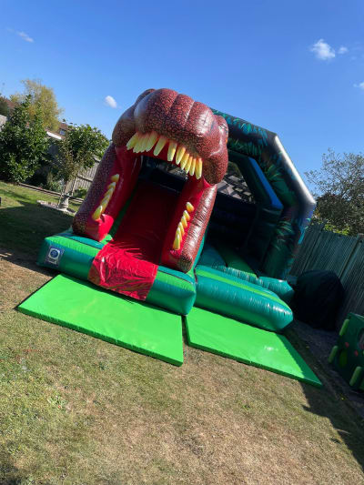 15x12ft 3D Dinosaur Front Slide Combi, a bounce and slide combo for hire from Bouncing Happy