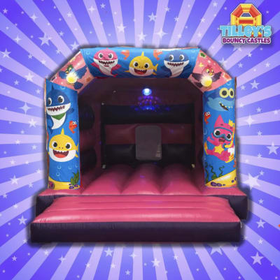 Baby Shark Disco Bouncy Castle (Pink & Purple), a toddler inflatable for hire from Tilley's Bouncy Castles and Soft Play Hire