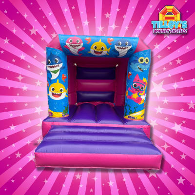 Baby Shark Bouncy Castle (Pink & Purple Slim), a toddler inflatable for hire from Tilley's Bouncy Castles and Soft Play Hire