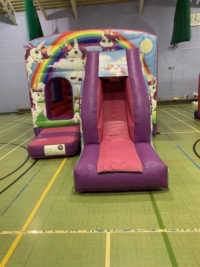 Magical unicorns bounce N slide castle, a bounce and slide combo for hire from Croydon Bouncy Castles