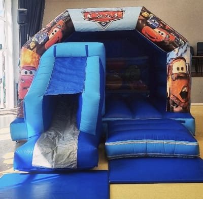 18ft x 12ft Cars Bouncy Castle With A Front Slide, a bounce and slide combo for hire from Bouncy Castle Factory