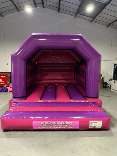 Glossy Pink & Purple Bouncy Castle (15x12ft), a bouncy castle for hire from The Bounce Generation