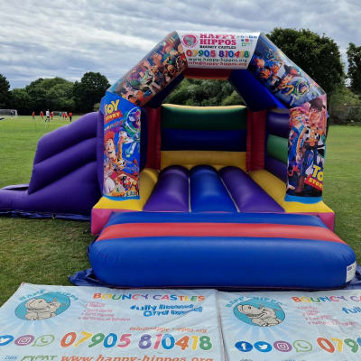 Toy Story Slide 15ft x 18ft - Purple & Red, a inflatable slide for hire from Happy Hippos Bouncy Castles