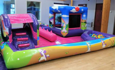 Deluxe Unicorn Playzone with slide, castle and Ball Pool, a bounce and slide combo for hire from Abc Party Hire