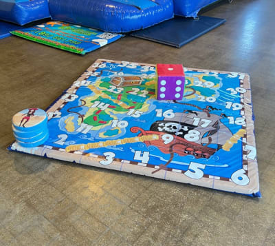 Giant Pirate theme snakes and ladders game, a inflatable game for hire from Wallington Bouncy Castles