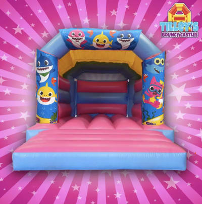 Baby Shark Bouncy Castle (Pink & Blue), a toddler inflatable for hire from Tilley's Bouncy Castles and Soft Play Hire