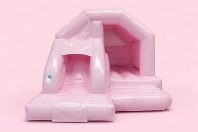 Pastel pink bounce and slide, a bounce and slide combo for hire from Croydon Bouncy Castles
