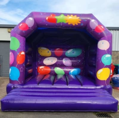 Purple baloon adults castle, a bouncy castle for hire from Bounce About Sussex
