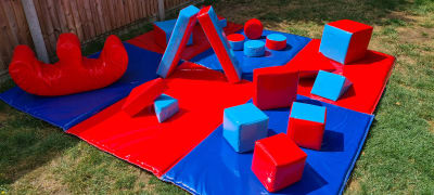 Red and Blue Soft Play + Double Rocker, a soft play set for hire from Bouncy Boss