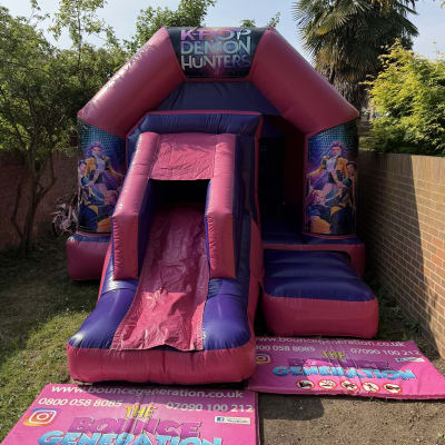 K Pop Demon Hunters bouncy castle with slide (17x12ft), a bounce and slide combo for hire from The Bounce Generation