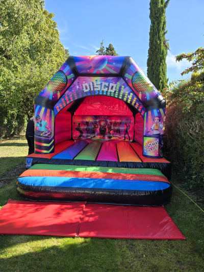 Multicoloured Disco Bouncy Castle, a bouncy castle for hire from Kendall's Castles