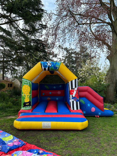 Football Bouncy Castle With Slide (15ft x 17ft), a bounce and slide combo for hire from The Bounce Generation