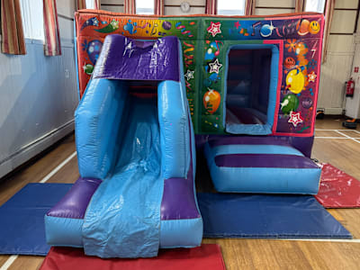 Party Theme (Low height Combi slide Castle ), a bounce and slide combo for hire from Bounce N Fun