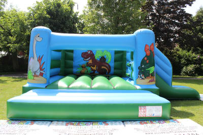 Dinosaur Castle/Slide Combo, a bounce and slide combo for hire from Allsorts Inflatables