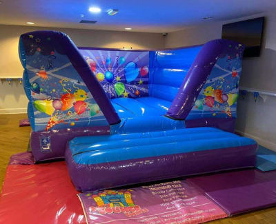 Blue & Purple V-Frame Castle, a bouncy castle for hire from Every Bounce Counts