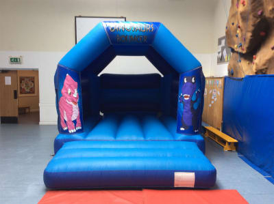 DINOSAUR BOUNCY CASTLE 15FT vs 11ft, a bouncy castle for hire from All Bounce Surrey