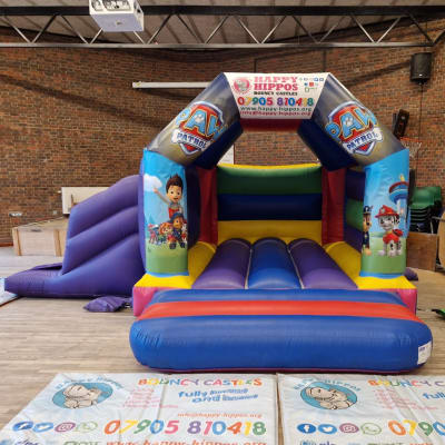 Paw Patrol Slide 15ft x 18ft - Purple & Red, a inflatable slide for hire from Happy Hippos Bouncy Castles
