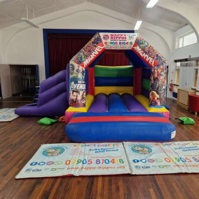 Marvel Slide 15ft x 18ft - Purple & Red, a inflatable slide for hire from Happy Hippos Bouncy Castles