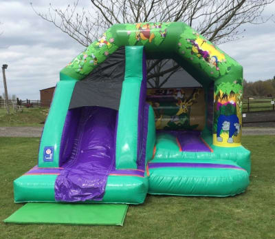 Slide Bouncer Bouncy Castle Jungle themed with Front Slide, a bounce and slide combo for hire from 1st Choice Inflatables