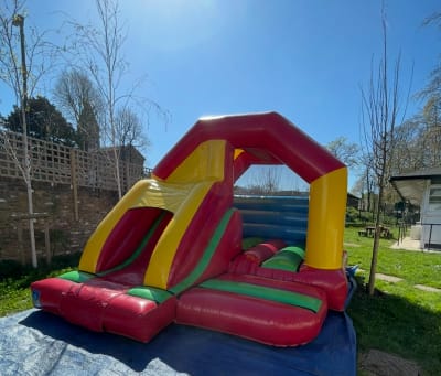 12 x 15 Multicoloured Front Slide Combi, a bounce and slide combo for hire from Wallington Bouncy Castles