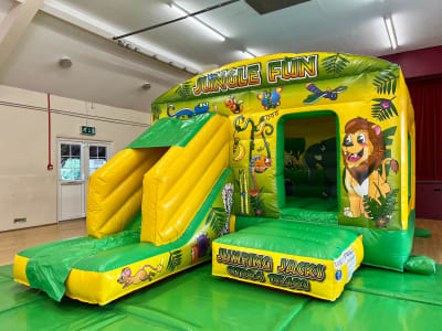 Jungle Castle with Slide, a bounce and slide combo for hire from Jumping Jacks Bouncy Castles