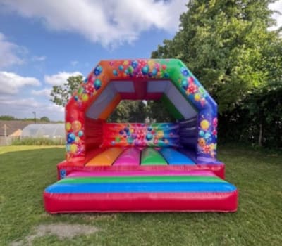 15x15 Multi coloured partytime castle, a bouncy castle for hire from Wallington Bouncy Castles