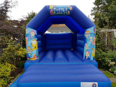 BUBBLE GUPPIES BOUNCY CASTLE 15FT vs 11ft, a bouncy castle for hire from All Bounce Surrey