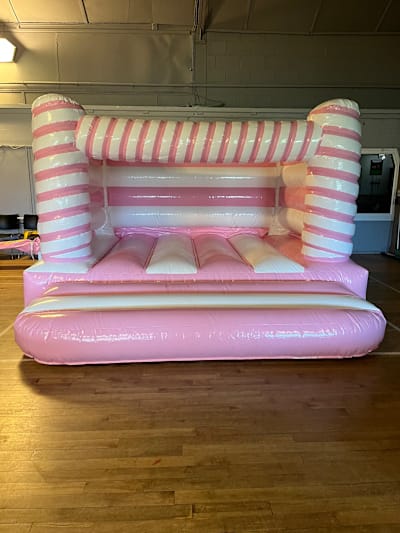 Pink and White Candy Cane Bouncy Castle, a bouncy castle for hire from Bounce House Inflatables