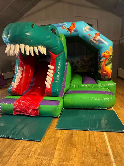 15 x12ft Dinosaur Front slide and bounce combo, a bounce and slide combo for hire from Bounce House Inflatables