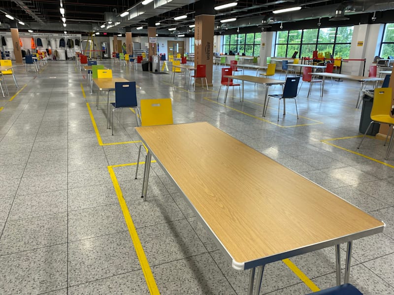 Rows of folding tables and chairs racked ready for delivery
