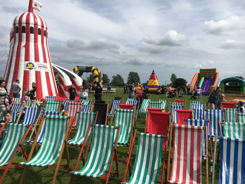 Striped deck chairs set out on grass at a fun day