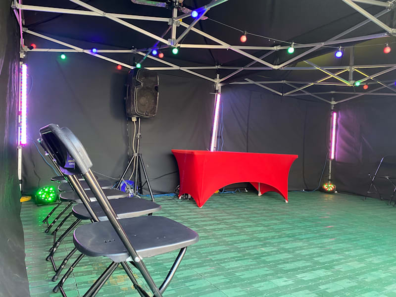 Foldable chairs and a dressed table inside an evening party marquee