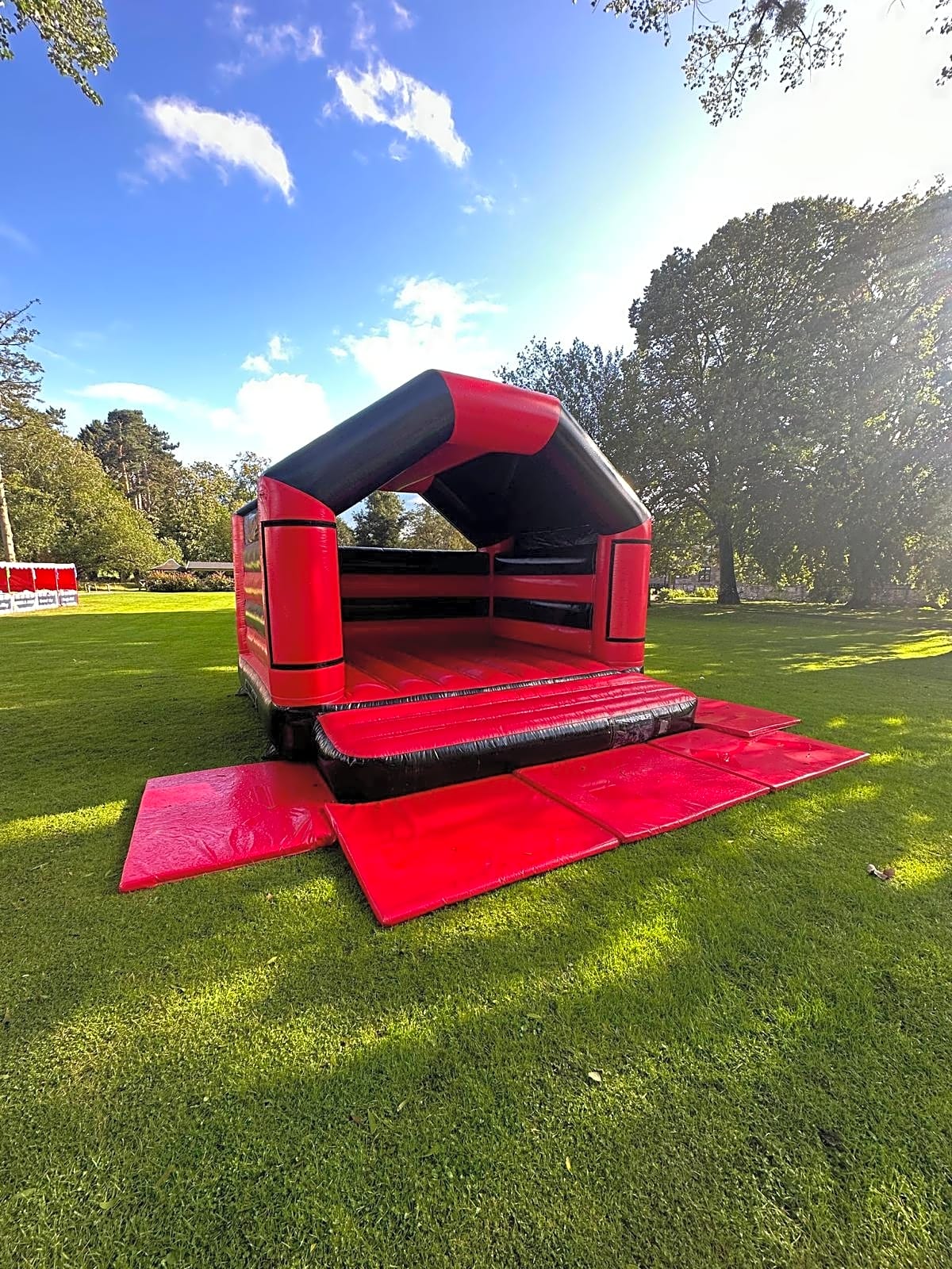 Adult Bouncy Castle Hire - Red and Black With Roof