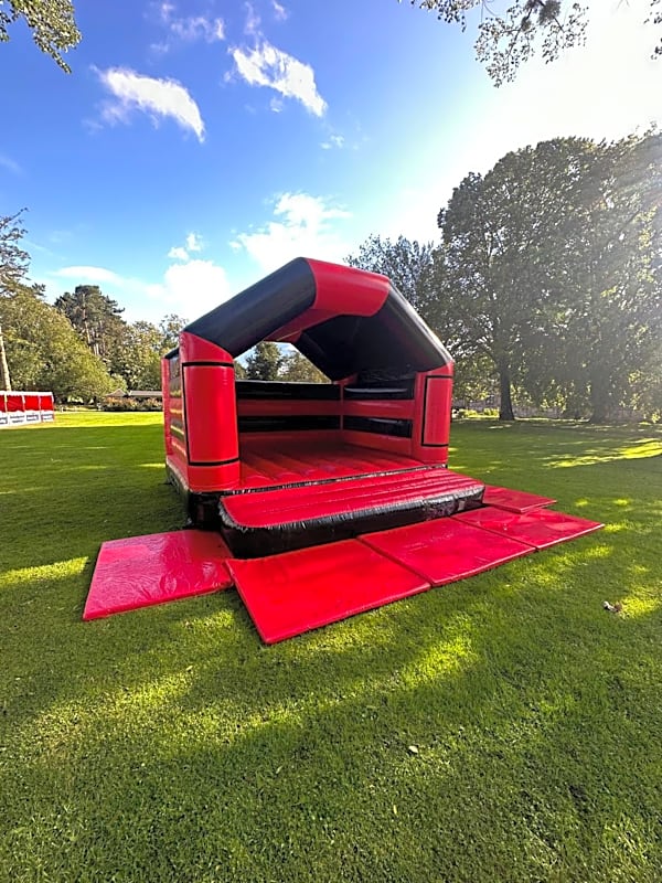 Adult Bouncy Castle Hire - Red and Black With Roof